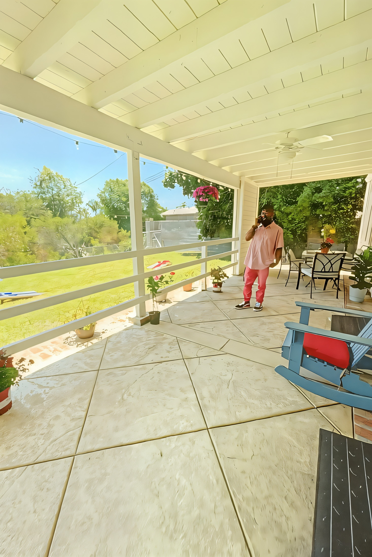 Front porch with hanging flower baskets and garden
